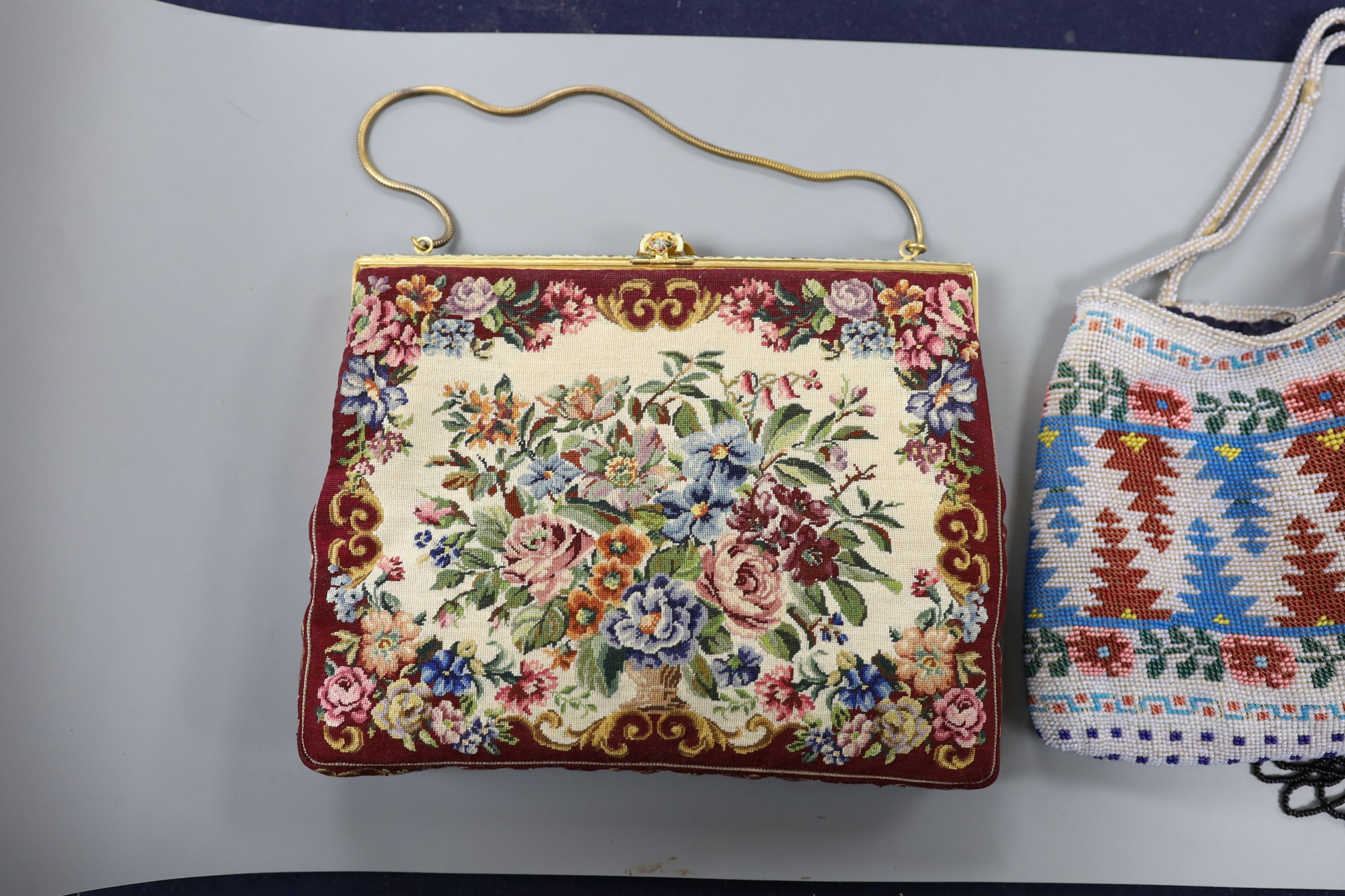 A fine needlework petit point evening bag, a 19th century bible bag, an early 20th century beaded bag and a 1930's beaded bag